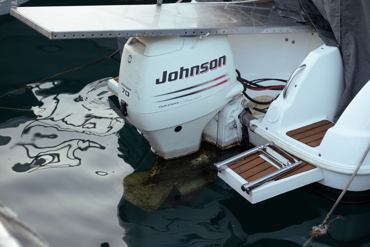 Close-up of an outboard motor mounted on the transom of a boat