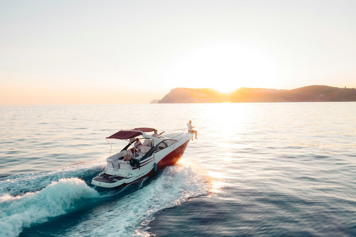 Outboard motor mounted on the transom of a small boat on calm water